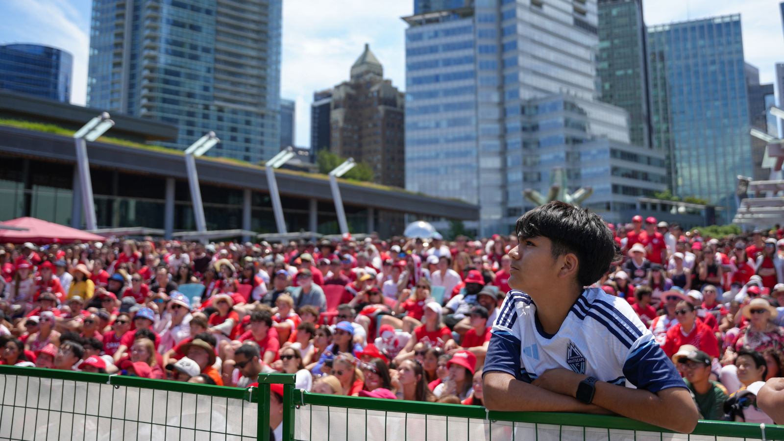 Boy in White Caps jersey with crowd behind him